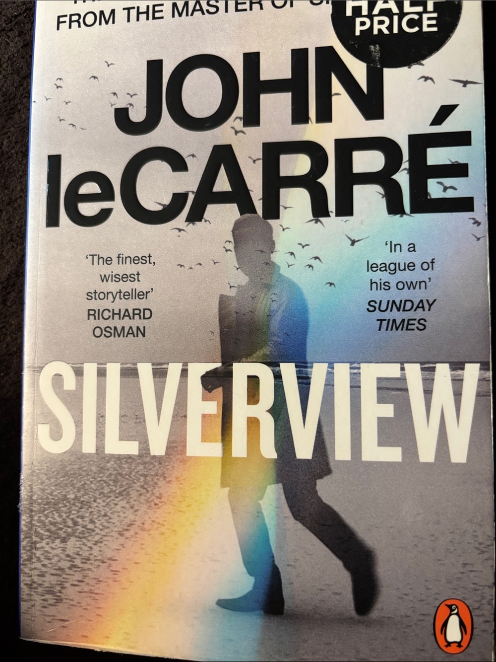 Original Penguin paperback back cover with blue, cream, brown and rainbow hues